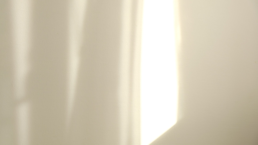 Morning sun lighting the room, shadow background overlays. Waving white tulle near the window. Royalty-Free Stock Footage #1059210533