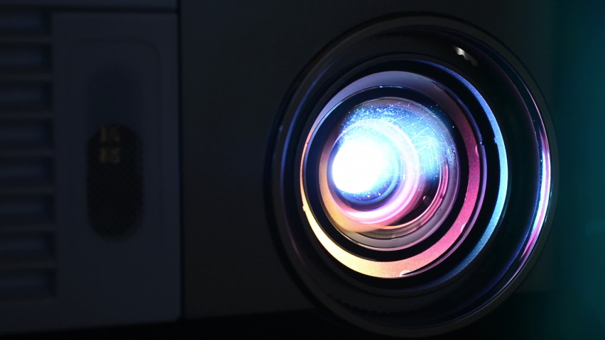 Lens with the color beam of a video projector Royalty-Free Stock Footage #1059210596