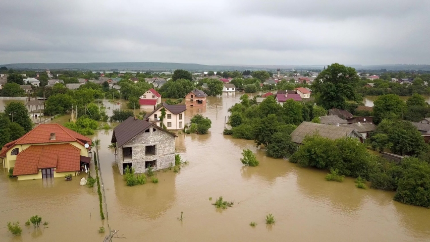 Aerial view of flooded houses with dirty water of Dnister river in Halych town, western Ukraine. | Shutterstock HD Video #1059216563