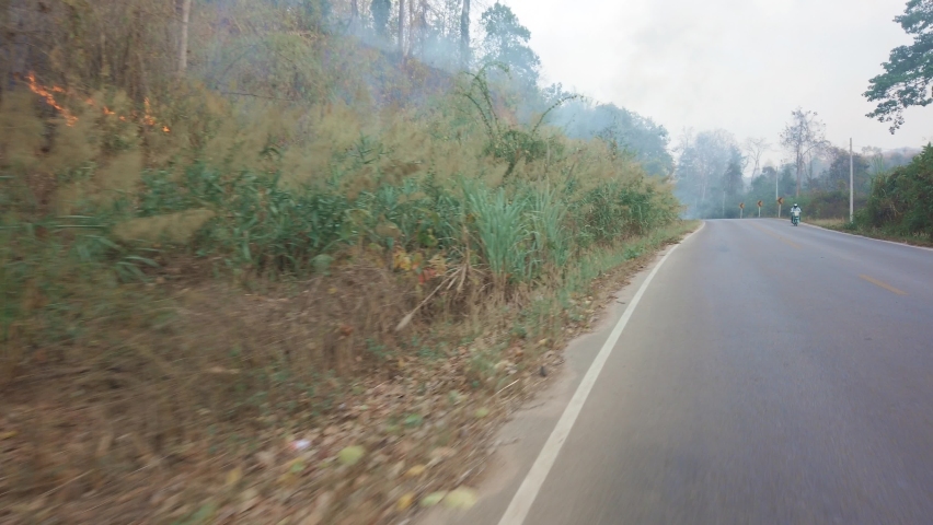 Driving along a mountine road while bushfire and smog season in Thailand. Point of view driving. POV driving footage 4K