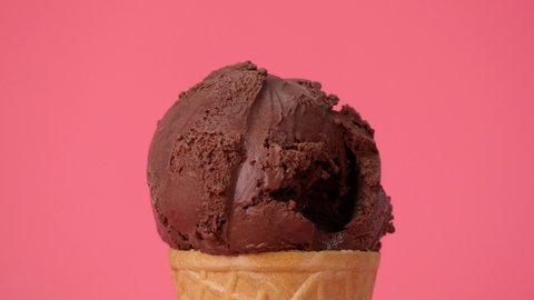 Scooping Ice cream Chocolate cone on pink background.