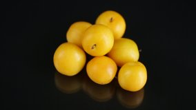 yellow cherry plums on the black background