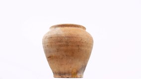 Ceramic clay jug on a white background. Ceramic pot. Old kitchen utensils. Handmade clay jug. White background. Video.