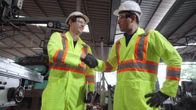 Factory worker warn coworker about safety and give hardhat to him . Injury prevention and safety first concept . - Powered by Shutterstock - Get 15% off with code: PIKWIZARD15