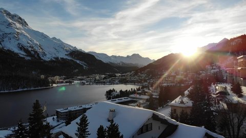 Drone flying over the village and lake in St Moritz at sunset