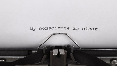 typing a quote my conscience is clear on a vintage typewriter close-up
