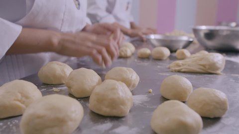 Chef hands preparing dough for bread, pasta or pizza. Hands mixing ingredients to prepare artisan bread, flour mixture, butter and ingredients to make bread. Baker working