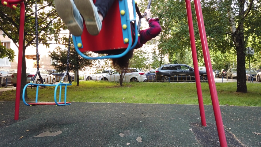 Woman on the Playground rides on a swing