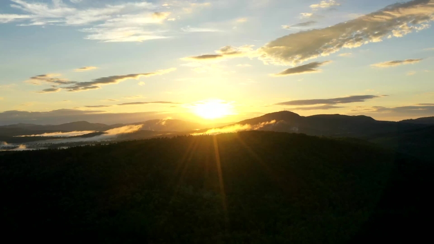 Aerial Time Lapse Sunrise over the Mountains of Maine- Fog / Mist over rolling hills and a Mountain range silhouette- blue sky morning sunshine