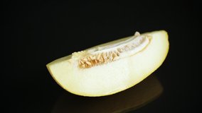 Studio shot of notched ripe melon galia with slice