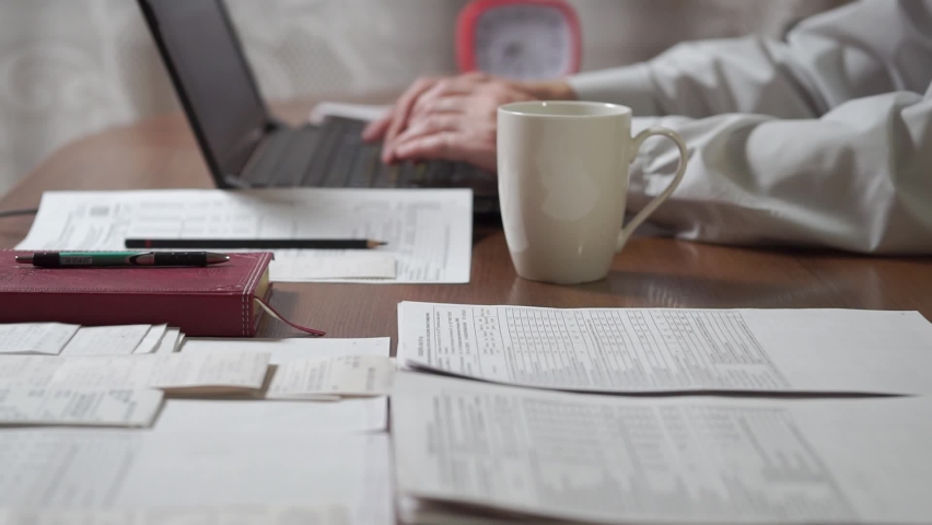 Man working at home office, spilled coffee on documents at workplace  Royalty-Free Stock Footage #1059257039