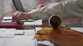 Man working at home office, spilled coffee on documents at workplace  - Powered by Shutterstock - Get 15% off with code: PIKWIZARD15