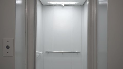Empty elevator in a residential building or office. Modern elevator or lift doors made of metal smoothly open and close