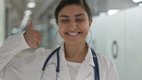 Portrait of Positive Indian Female Doctor doing Thumbs Up 