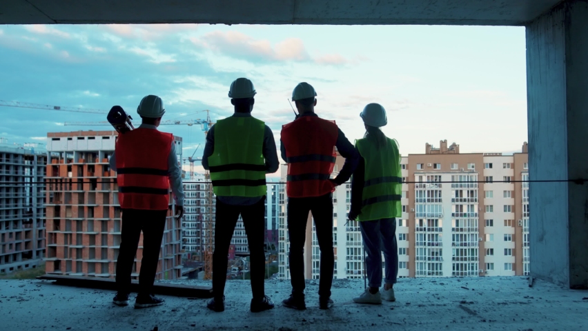 Shot back builders engineers workers in hard hat team walking on construction at sunlight survey urban meeting skyscraper builder architect contractor inspector construction helmet slow motion Royalty-Free Stock Footage #1059264581