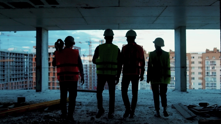 View of shot back builders engineers workers in hard hat team walking on construction at sunlight survey urban meeting skyscraper builder architect contractor inspector construction helmet slow motion Royalty-Free Stock Footage #1059264587