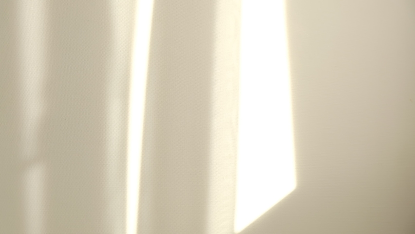 Morning sun lighting the room, shadow background overlays. Waving white tulle near the window. Royalty-Free Stock Footage #1059266324