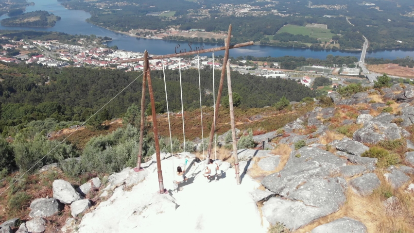 DRONE AERIAL FOOTAGE - The CerLove giant wooden swing in Vila Nova de Cerveira, Portugal. The swing of the valley of Minho is next to the viewpoint of  of Cervo. People on swings admire the view.