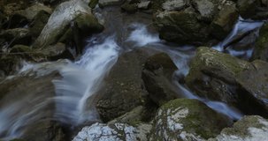 Stunning 4k Time-lapse video for waterfall running through rocks covered with green algae in tropical rainforest jungle in Natural Sassenage area at Grenoble France.