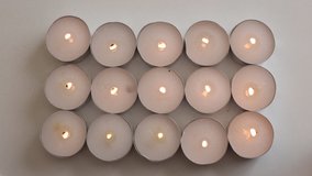 mourning burning candles, festive background of many lights