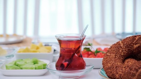 Traditional Turkish breakfast prepared with bagel and tea camera moves away from tea glass