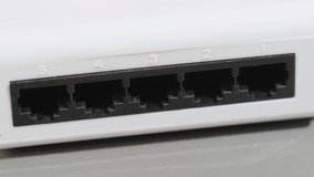 Male Hand Inserts  Data Lan Cable  Into Network Switch in Data Center. close up