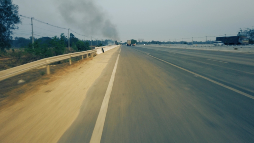Driving along a mountine road while bushfire and smog season in Thailand. Point of view driving. POV driving footage 4K
