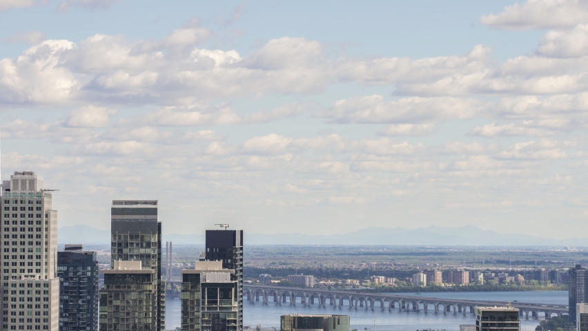 Time lapse of high rise building and bridge on the background