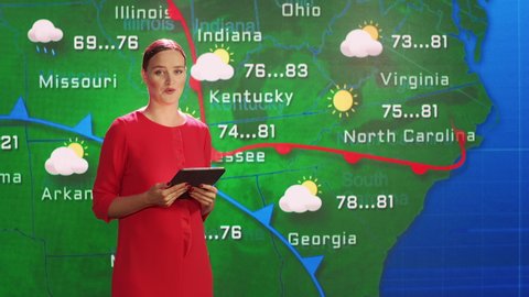 Weather News Studio Female Meteorologist Points at Weather Map.
