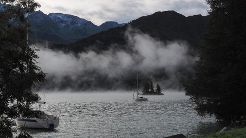 Maloja mountain Pass, Switzerland. September 20, 2020. Landscape of the lake Sils in the morning at fall time. The fog covers the lake and the shores. Traditional Swiss contest. Natural landscape