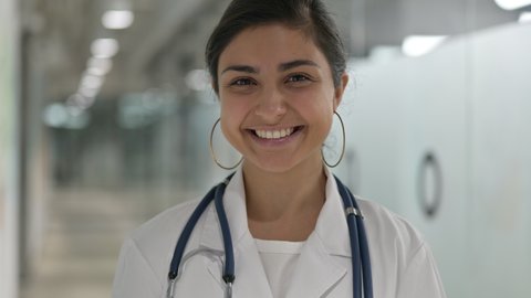 Portrait of Smiling Indian Female Doctor Looking at Camera 