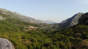 Aerial view Montenegro. Drone video of the mountains with a beautiful landscape of rocks, the tops of which are houses with red roofs.