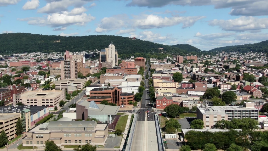 Aerial pullback, Reading PA, Pennsylvania USA United States urban city, Schuylkill River, summer day under beautiful clouds and sky