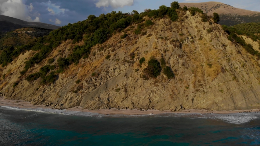 Mountains and rocky hills on seaside of Southern Albania bordered by blue azure sea water