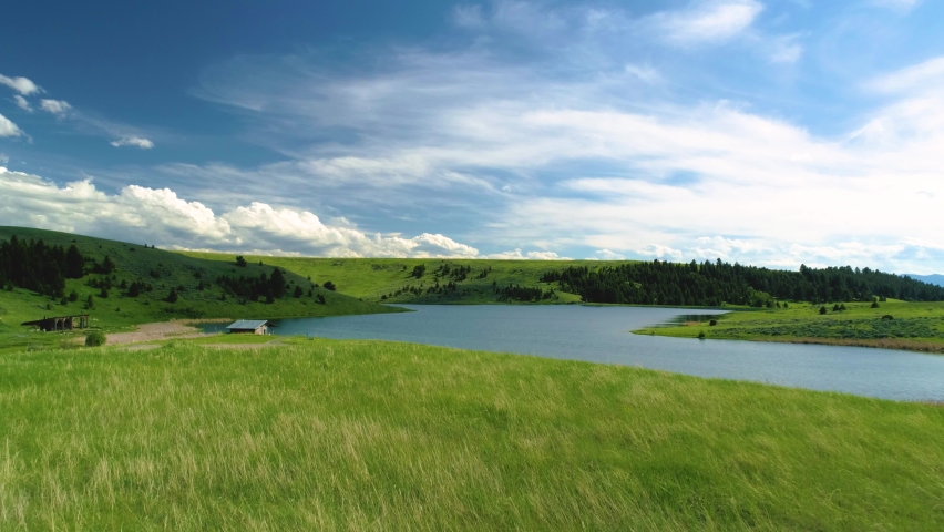 Aerial View Crazy Mountain Montana Landscape sunset horses pastures feeding wide angle drone shot