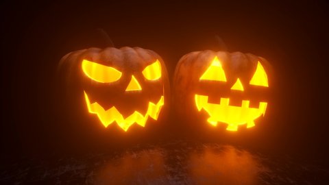 Halloween pumpkins are burning, glowing and sparkling from the inside on a black background. Ultra HD 4k seamless loop animation for festive horror decoration.