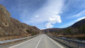 Time lapse video of driving along mountain asphalt road Chuysky Tract along Kurai Ridge on Altai betveen Aktash and Kuray at Spring season. Siberia, Russia