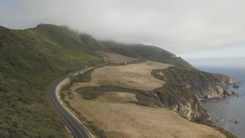 West Coast USA. Big Sur Coastline and Traffic on State Route 1 by Pacific Ocean. Drone Aerial View