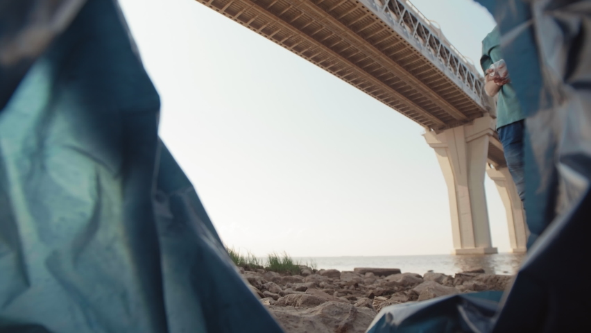 Lockdown of litter bag and three unrecognizable eco-activists putting different rubbish in it