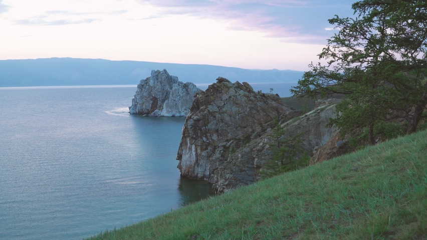 Shamanka Rock on Olkhon. one of the nine Holy places of Asia. Cape Burhan. rock is composed of marble and limestone, sometimes abounding with graphite spangles. landscape of Siberian Baikal Lake.