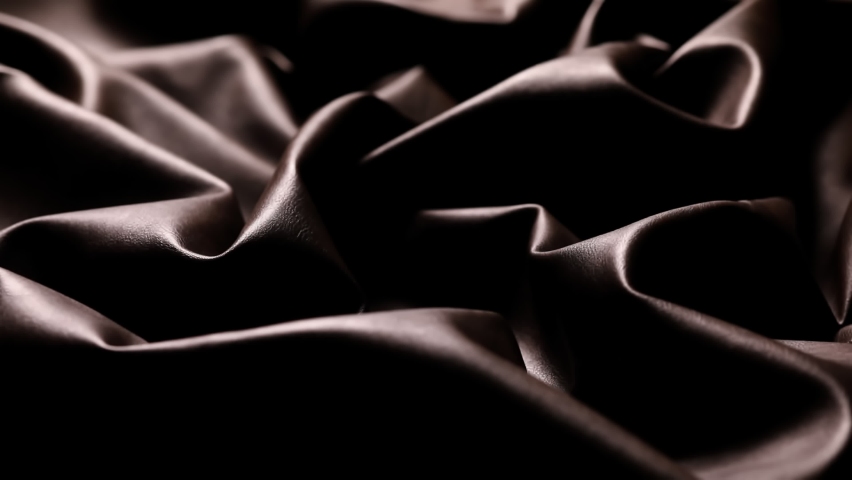 Light moving on Chocolate color leather wavy surface and luminating the texture. Textile abstract background. Close up, Amazing Lights and shadows