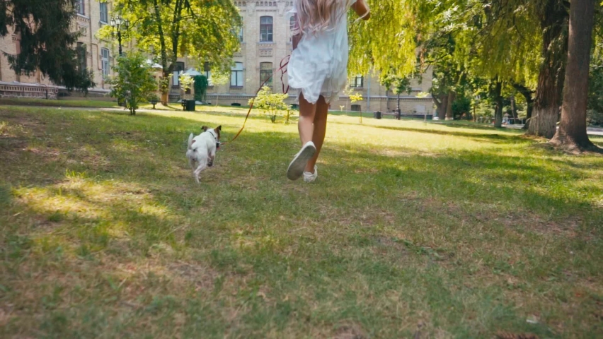 kid in dress running with jack russell terrier