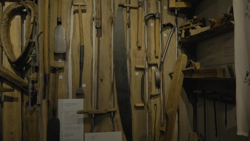 Old Hand Tools Hanging On A Wall In A Vintage Shop In Swornegacie, Northern Poland - Closeup Pan Left