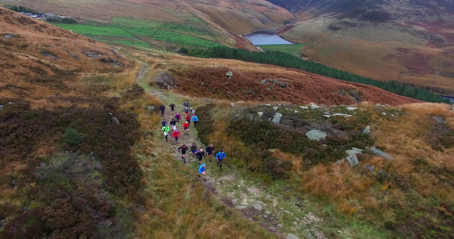 Group of athletes running up rocky hill / Yorkshire Moors, Yorkshire, UK | Shutterstock HD Video #1059408839
