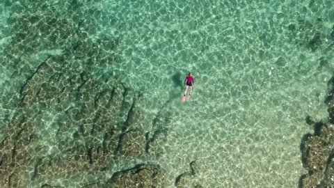 Aerial view of woman snorkelling in tropical turquoise ocean in Mexico