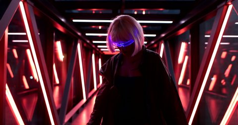 Futuristic style. Cyberpunk woman in neon glasses. High quality 4k footage