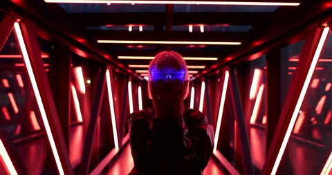 Futuristic style. Cyberpunk woman in neon glasses. High quality 4k footage