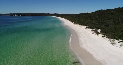 Remote white sand dunes beach on Jervis Bay in Australia – aerial 4k.
