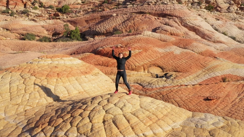 Woman Exercising and doing Jumping Jacks in the Desert