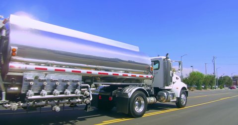 Gasoline oil trailer truck tanker driving to the gas station on the street of Los Angeles, California, 4K